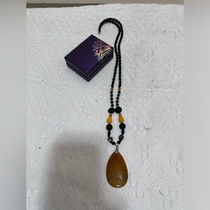 Beaded necklace with large stone charm